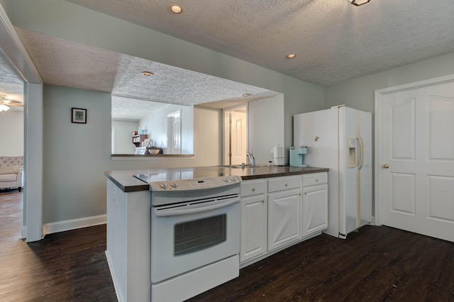 kitchen with white cabinetry, white appliances, dark hardwood / wood-style flooring, and a textured ceiling