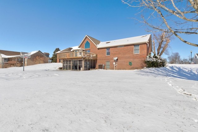 snow covered house featuring a deck