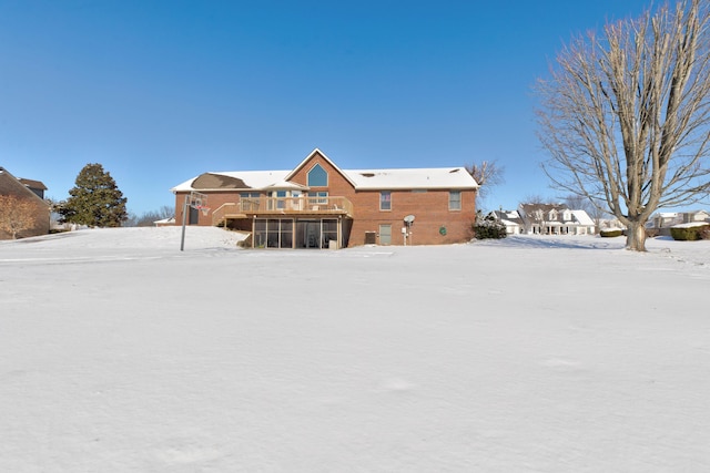 snow covered property with a wooden deck