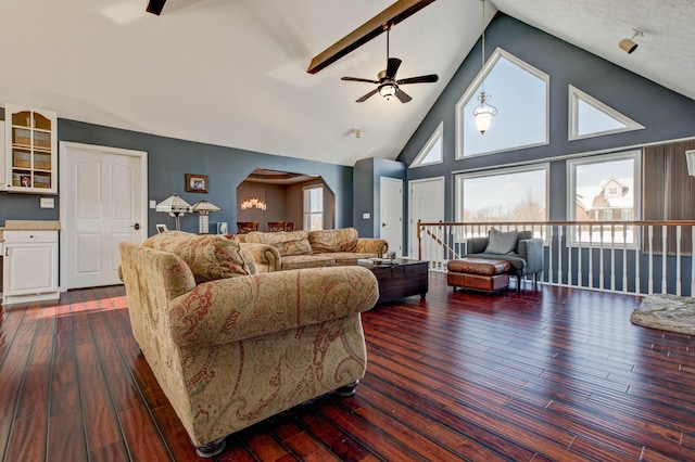 living room featuring dark wood-type flooring, beamed ceiling, high vaulted ceiling, and ceiling fan