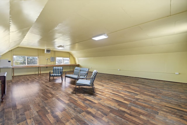 living area featuring lofted ceiling and dark hardwood / wood-style floors