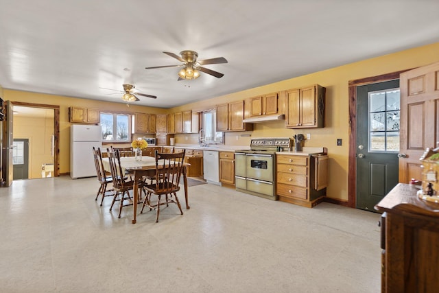 kitchen featuring ceiling fan, sink, and white appliances