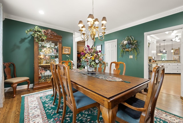 dining room featuring a notable chandelier, crown molding, and light hardwood / wood-style floors