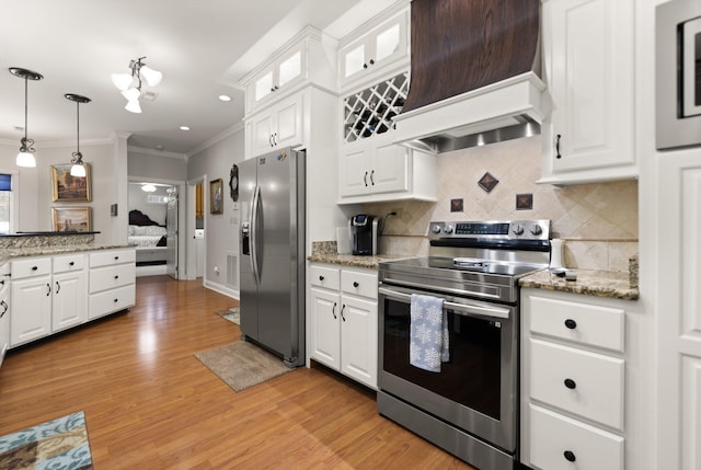 kitchen with pendant lighting, white cabinetry, backsplash, stainless steel appliances, and light hardwood / wood-style floors