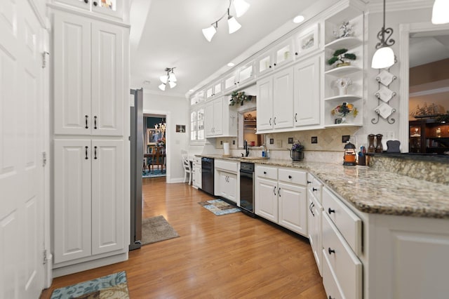 kitchen with decorative light fixtures, dishwasher, light stone countertops, and white cabinets