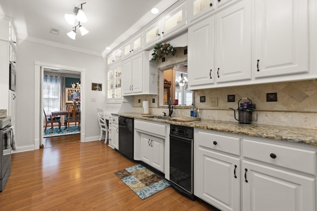 kitchen featuring crown molding, light hardwood / wood-style flooring, appliances with stainless steel finishes, white cabinetry, and a healthy amount of sunlight