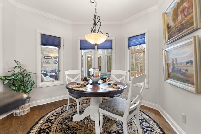 dining space with crown molding and dark hardwood / wood-style flooring