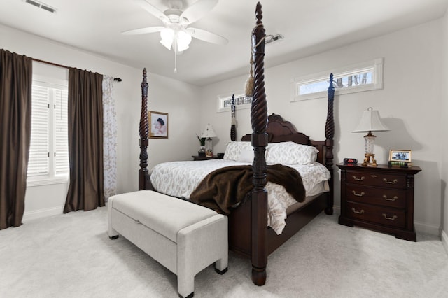 bedroom featuring multiple windows, light carpet, and ceiling fan