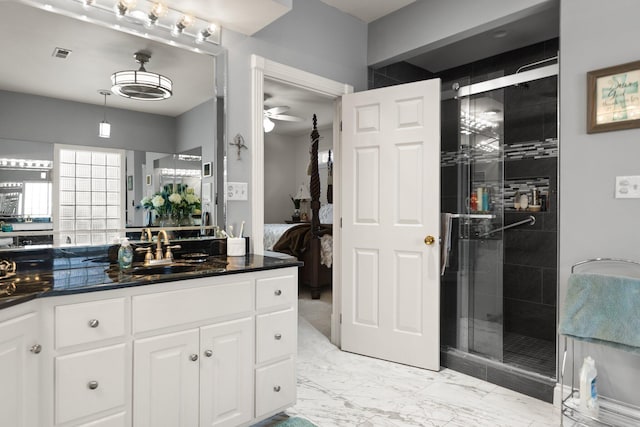 bathroom with ceiling fan, vanity, and a shower with shower door