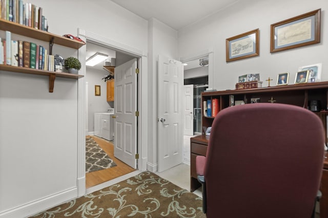 office with washer / clothes dryer and light hardwood / wood-style floors