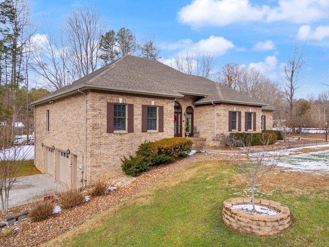 ranch-style house featuring a garage and a front yard