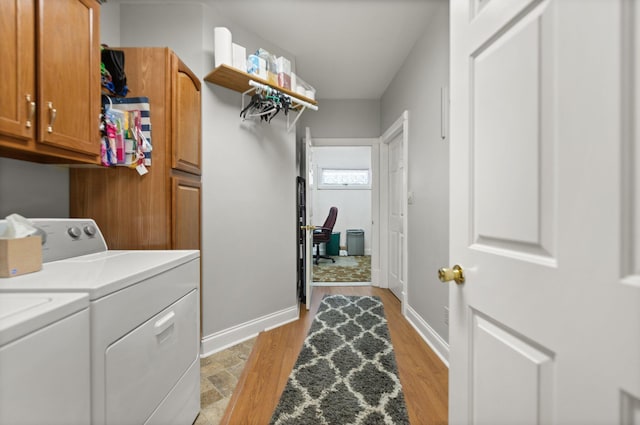 washroom featuring cabinets and washer and dryer