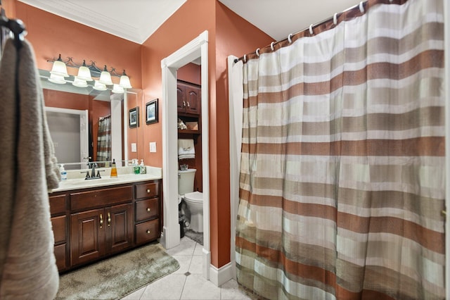 bathroom featuring ornamental molding, vanity, toilet, and tile patterned flooring