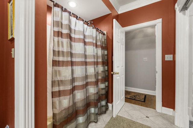 bathroom with crown molding and tile patterned floors