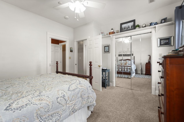 carpeted bedroom featuring ceiling fan and a closet