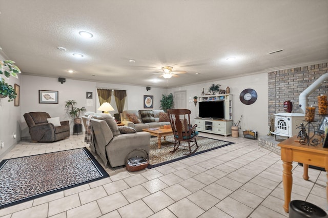 tiled living room with crown molding, ceiling fan, a textured ceiling, and a wood stove