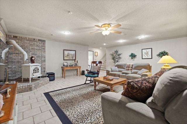 living room with crown molding, light tile patterned flooring, a textured ceiling, and a wood stove