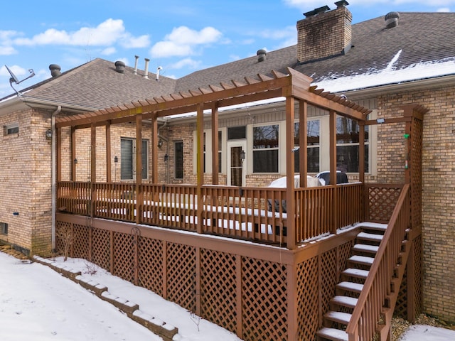 snow covered house with a deck