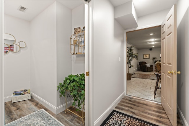 hallway with hardwood / wood-style flooring