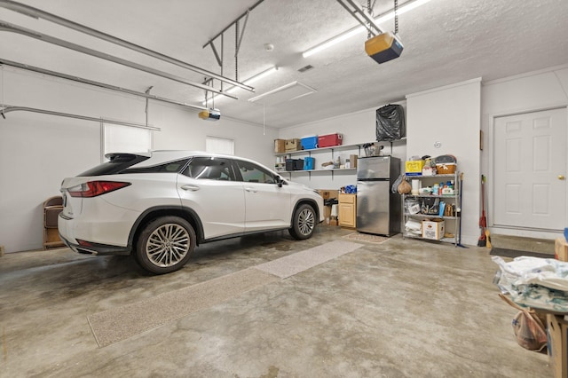 garage featuring a garage door opener and stainless steel fridge