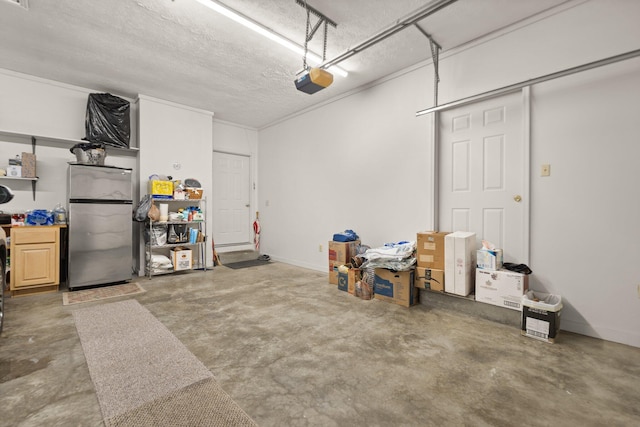 garage with a garage door opener and stainless steel refrigerator