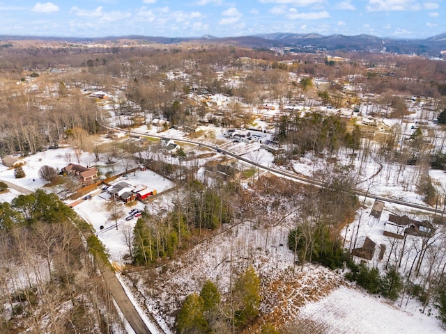 snowy aerial view featuring a mountain view