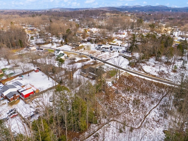 snowy aerial view featuring a mountain view