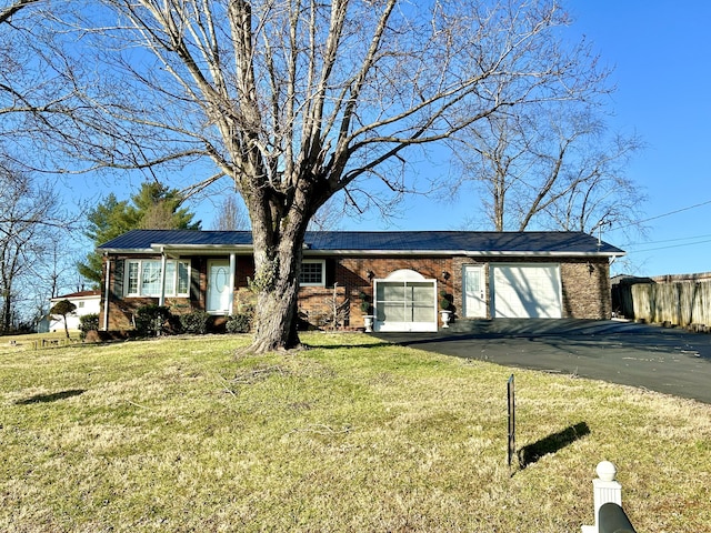 ranch-style home with a garage and a front yard