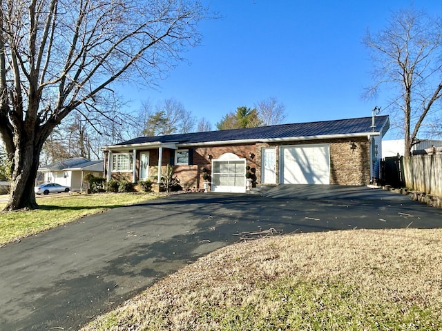 ranch-style home with a garage and a front lawn