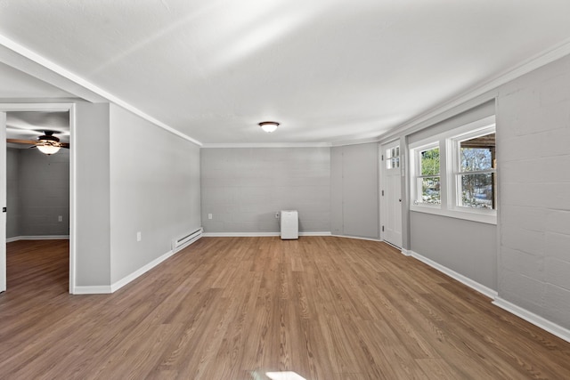 unfurnished room with ceiling fan, hardwood / wood-style floors, a baseboard heating unit, and crown molding