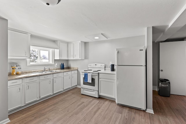 kitchen featuring sink, white appliances, and white cabinets