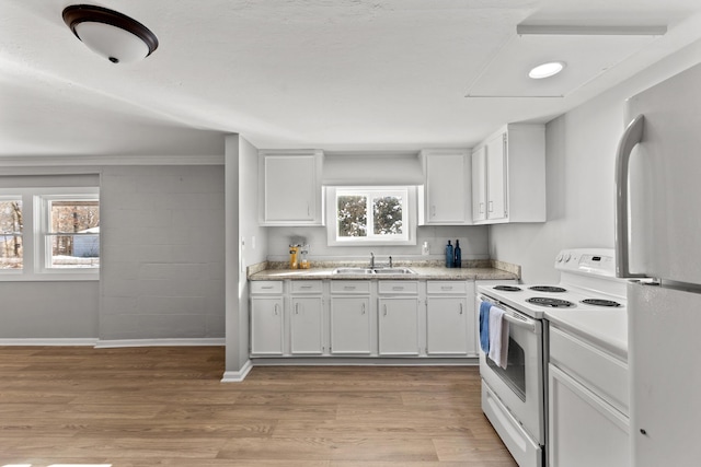 kitchen featuring white cabinetry, sink, white appliances, and light wood-type flooring