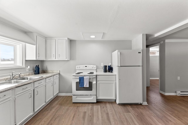 kitchen with sink, white cabinetry, white appliances, and a wealth of natural light