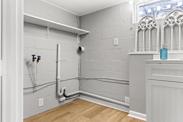 laundry room with wood-type flooring