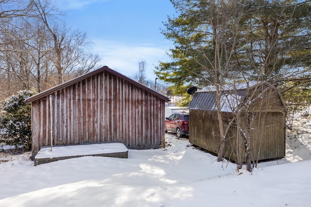 view of snow covered exterior featuring a storage unit