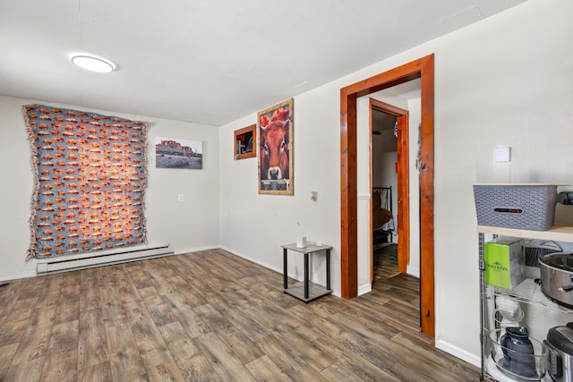 unfurnished room featuring a baseboard radiator and dark hardwood / wood-style flooring