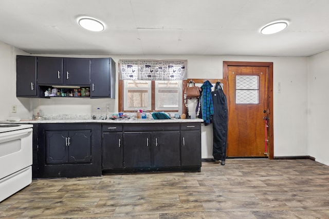 kitchen with white electric range oven and light wood-type flooring