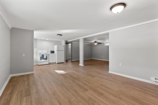 unfurnished living room featuring ceiling fan and light hardwood / wood-style floors