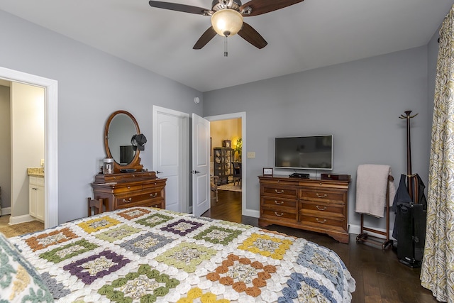 bedroom featuring ensuite bathroom, wood finished floors, a ceiling fan, and baseboards