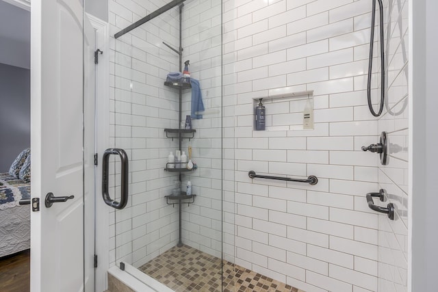 ensuite bathroom featuring a stall shower and connected bathroom