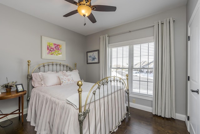 bedroom with ceiling fan, dark wood-style flooring, and baseboards