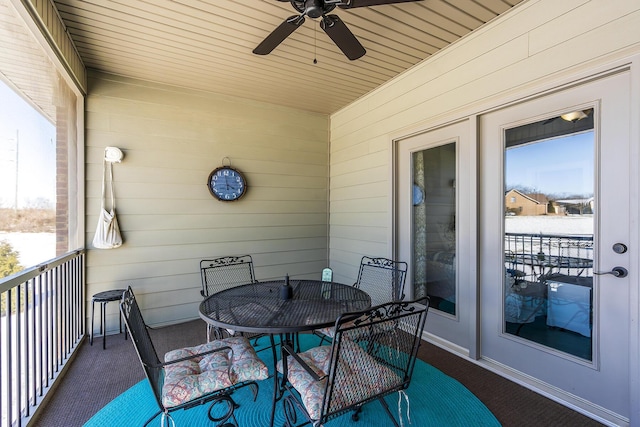 balcony featuring a ceiling fan and outdoor dining space