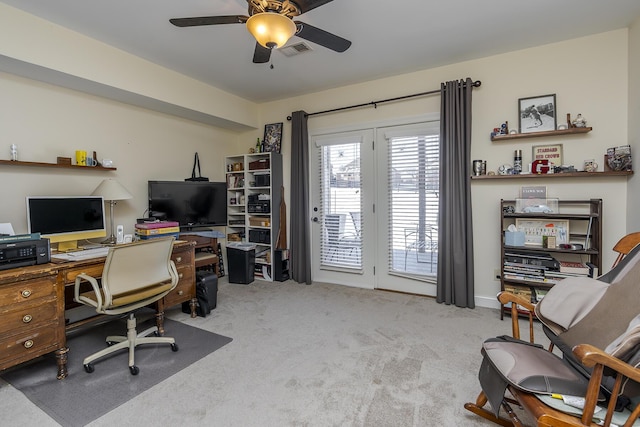 carpeted office space with visible vents and ceiling fan