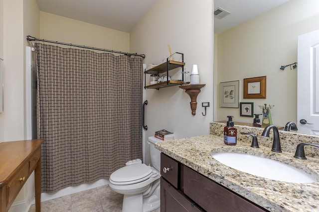 bathroom with toilet, vanity, tile patterned flooring, and visible vents