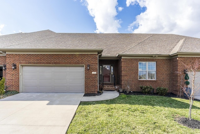 single story home featuring a front lawn, an attached garage, brick siding, and a shingled roof