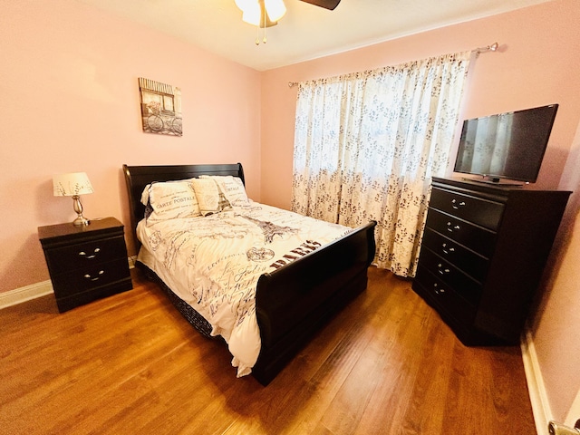 bedroom with ceiling fan and dark hardwood / wood-style flooring