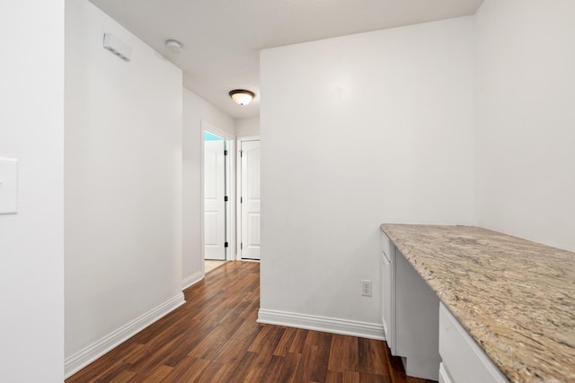 hallway with dark hardwood / wood-style floors