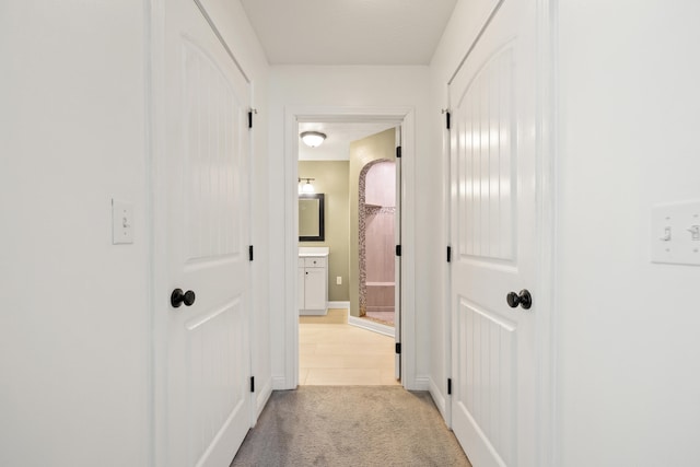 hallway with light colored carpet