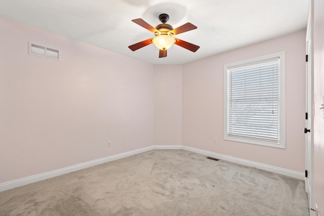 unfurnished room featuring ceiling fan and light carpet