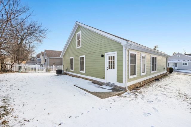 view of snowy exterior with central AC